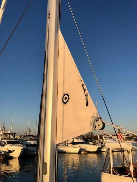Slide: The Image of Beneteau Oceanis 46.1 sailboat mast and sail at sunset, 2023 model. - 24
