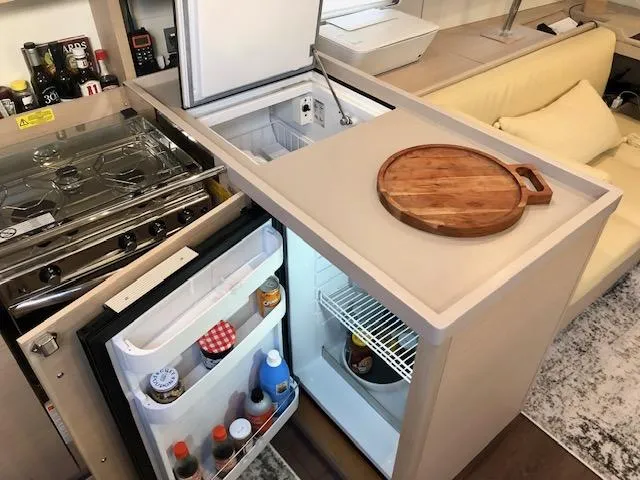 Slide: The Image of Modern kitchen area in 2023 Beneteau Oceanis 46.1 yacht with fridge and stove. - 26