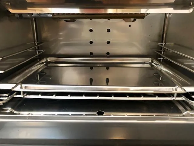 Slide: The Image of Inside view of a clean, empty oven with metal racks. - 27