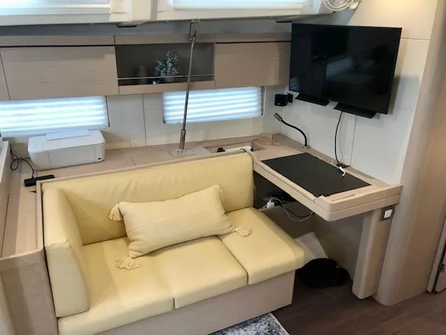 Slide: The Image of Interior of 2023 Beneteau Oceanis 46.1 yacht with cozy seating and modern amenities. - 37