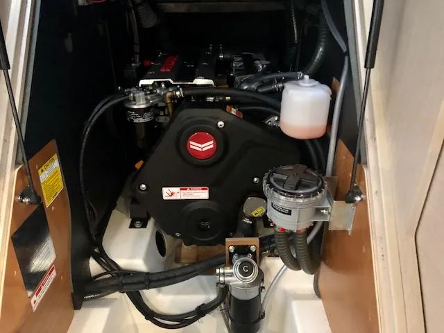 Slide: The Image of Engine compartment of 2023 Beneteau Oceanis 46.1 sailboat, showcasing mechanical components and wiring. - 39