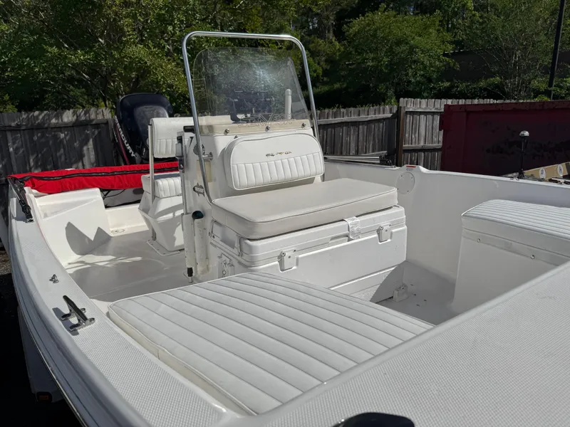 Slide: The Image of 2006 Sea Fox 185 Bay Fisher boat with white seating and console, parked outdoors. - 11