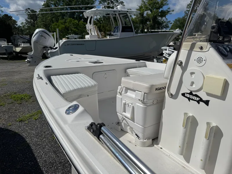Slide: The Image of 2006 Sea Fox 185 Bay Fisher boat with seating and storage, parked outdoors. - 7