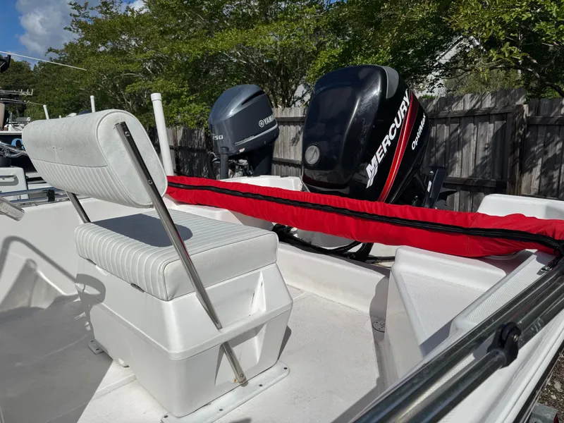 Slide: The Image of 2006 Sea Fox 185 Bay Fisher boat with Mercury outboard motor, white seating, and red cover. - 8