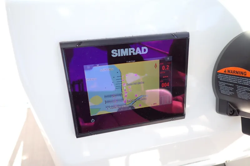 Slide: The Image of Simrad navigation display on 2021 NauticStar 223 DC boat dashboard. - 13