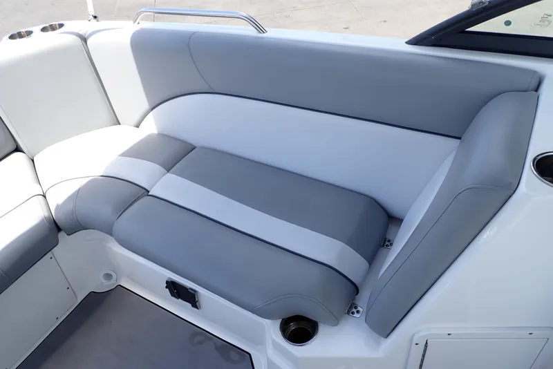 Slide: The Image of 2021 NauticStar 223 DC boat interior with gray and white cushioned seating. - 17