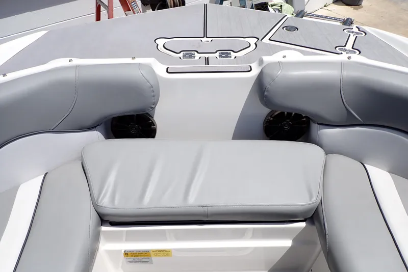 Slide: The Image of 2021 NauticStar 223 DC boat interior with gray cushioned seating and sleek design. - 18