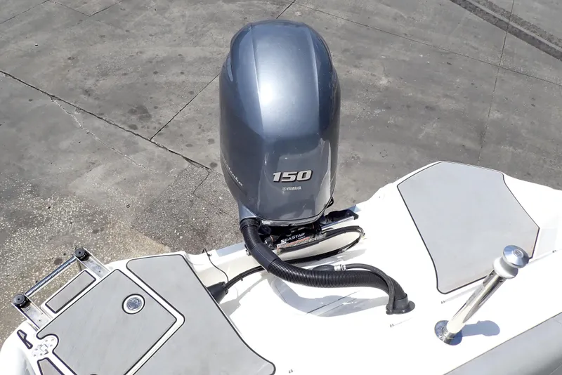 Slide: The Image of 2021 NauticStar 223 DC boat with Yamaha 150 engine, rear view. - 23