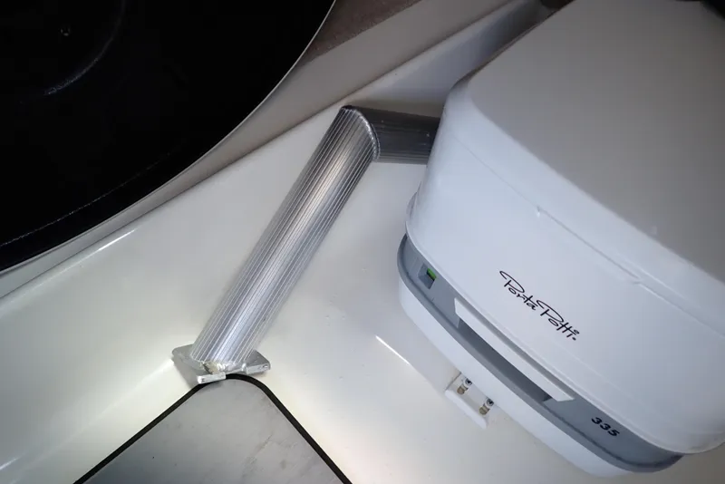 Slide: The Image of Portable toilet and vent pipe on 2021 NauticStar 223 DC boat. - 26