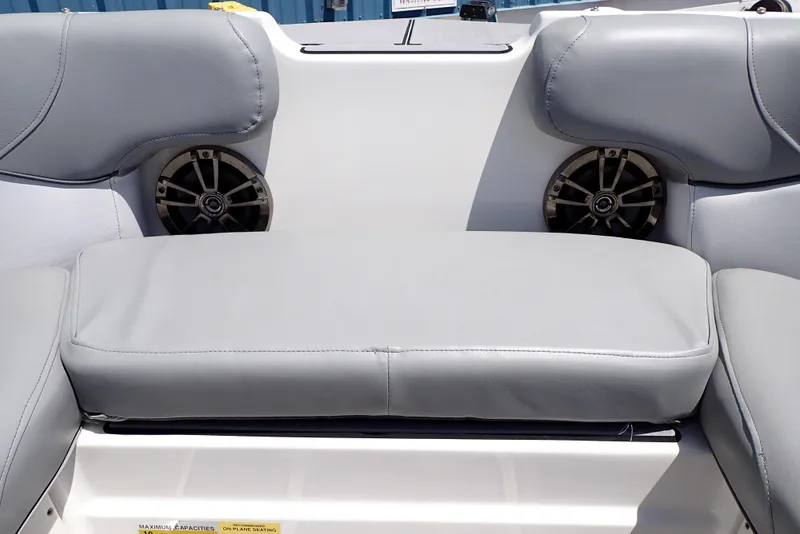 Slide: The Image of 2021 NauticStar 223 DC boat interior with gray seating and built-in speakers. - 31