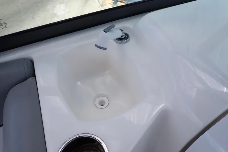 Slide: The Image of 2021 NauticStar 223 DC boat sink with faucet and cup holder. - 45