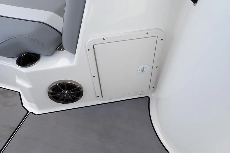 Slide: The Image of 2021 NauticStar 223 DC interior detail with speaker, storage compartment, and seating. - 46