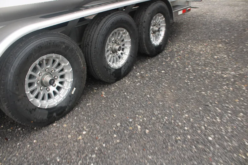 Slide: The Image of Triple axle trailer with silver alloy wheels for 2024 Fountain 34 SC boat. - 13