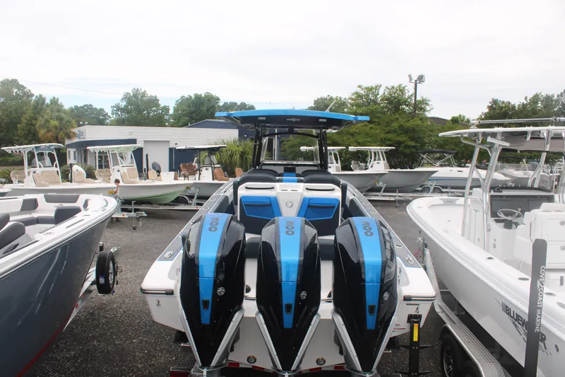 Slide: The Image of 2024 Fountain 34 SC boat with triple engines, displayed in a marina setting. - 15