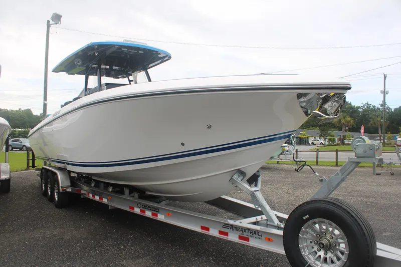 Slide: The Image of 2024 Fountain 34 SC boat on trailer, sleek design, parked outdoors. - 2