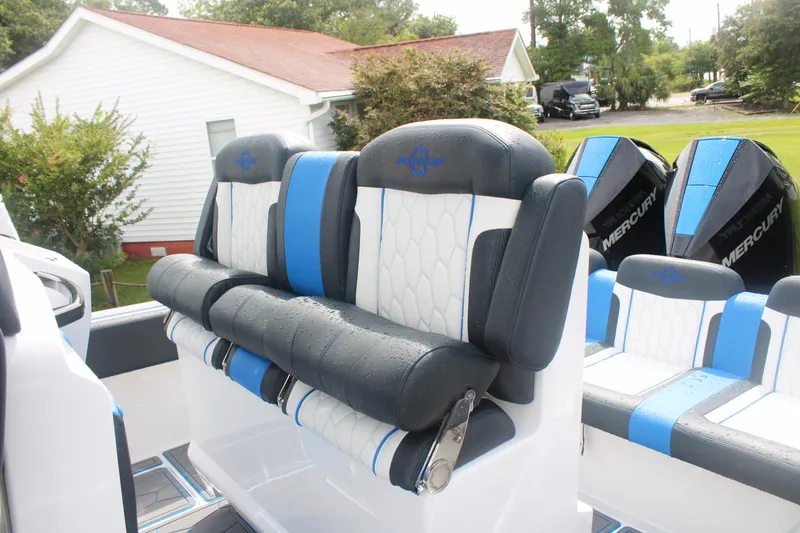 Slide: The Image of 2024 Fountain 34 SC boat interior with blue and white seating and Mercury engines. - 23