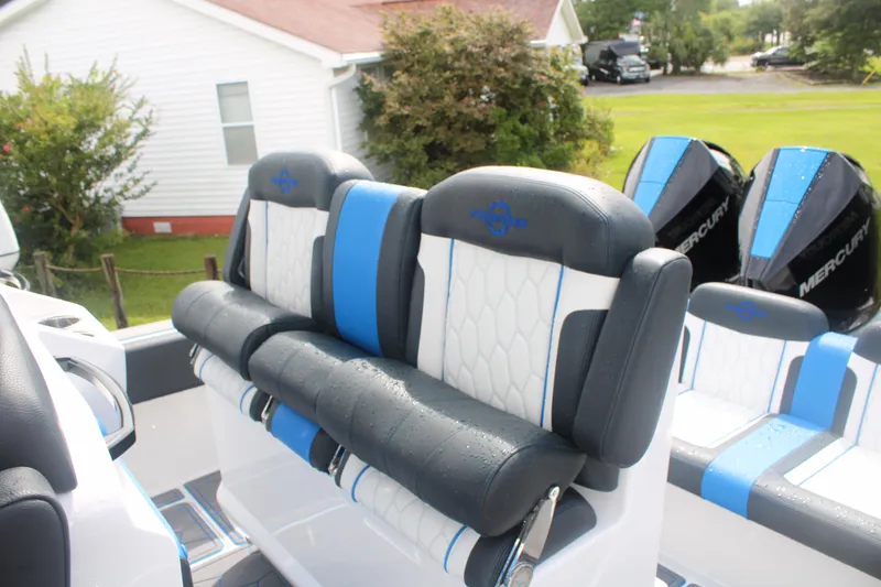 Slide: The Image of 2024 Fountain 34 SC boat seats with blue and white upholstery, featuring Mercury engines. - 24