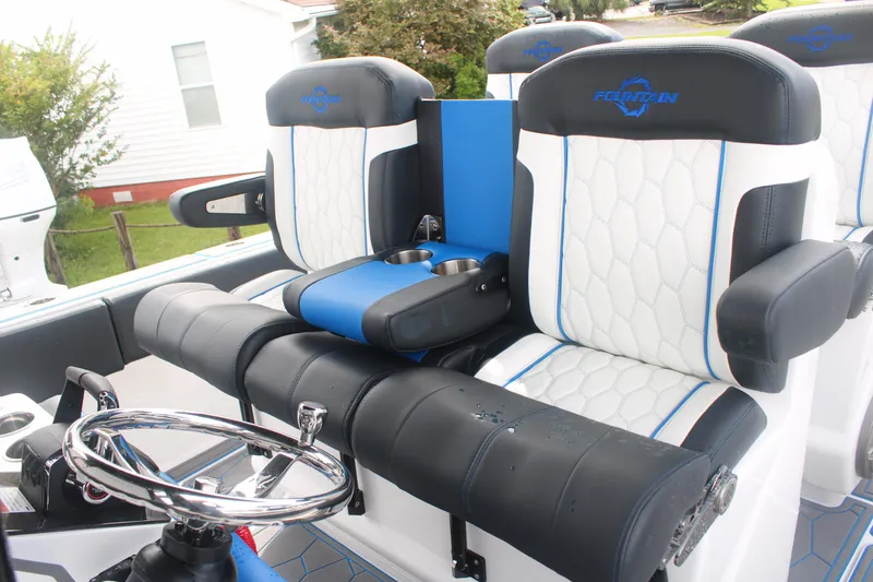 Slide: The Image of 2024 Fountain 34 SC boat interior with luxurious seating and steering wheel. - 31