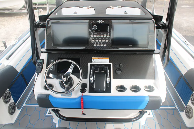 Slide: The Image of 2024 Fountain 34 SC boat dashboard with steering wheel and control panel. - 34