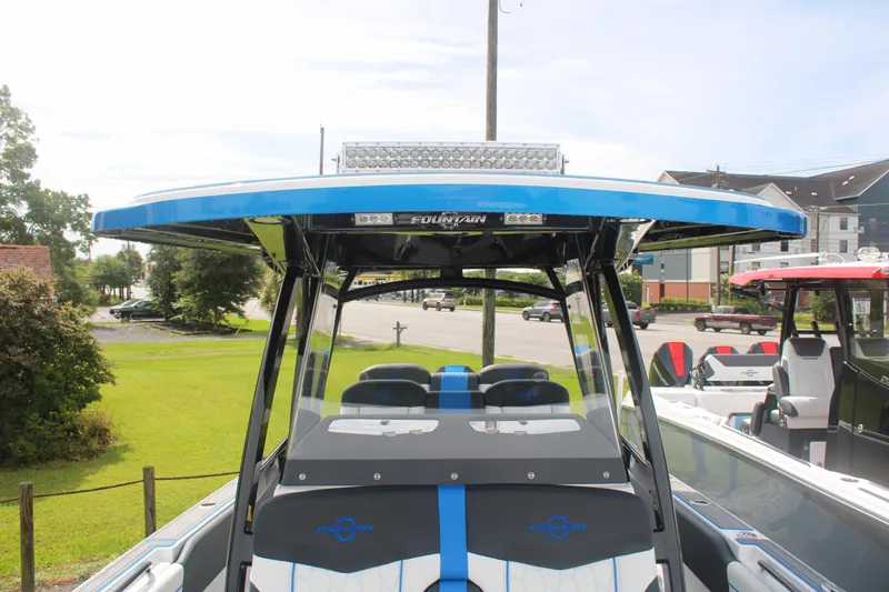 Slide: The Image of 2024 Fountain 34 SC boat with sleek design and modern features, docked outdoors. - 36