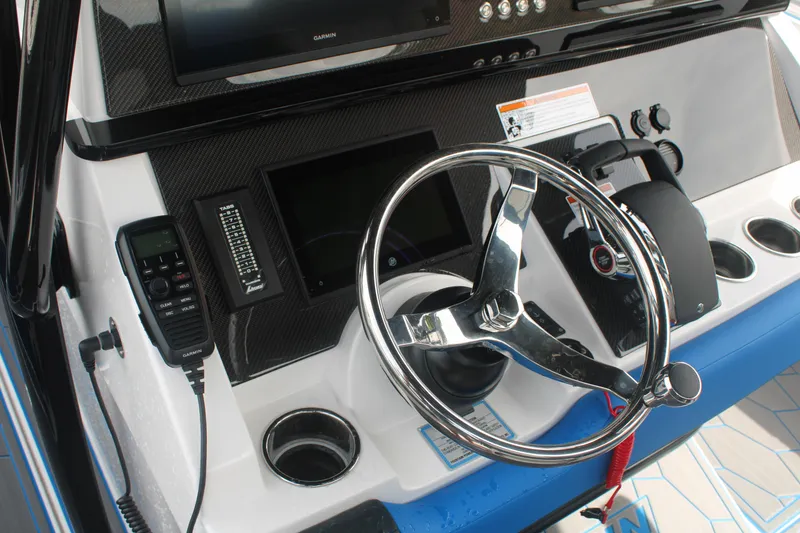Slide: The Image of 2024 Fountain 34 SC boat dashboard with steering wheel and control panel. - 37