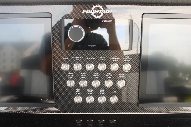 Slide: The Image of 2024 Fountain 34 SC dashboard with dual screens and control panel. - 38