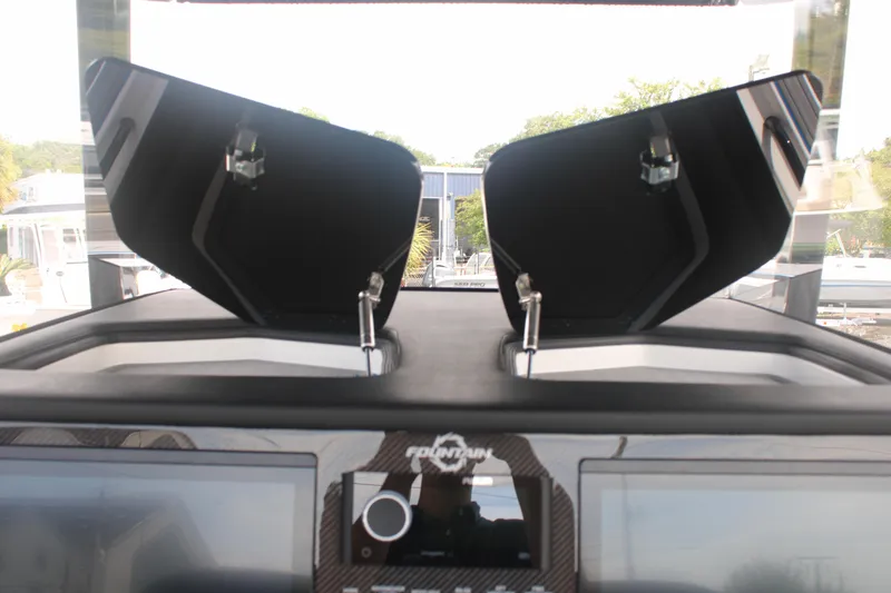 Slide: The Image of 2024 Fountain 34 SC dashboard with open compartments and control panel. - 40