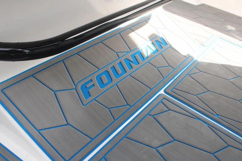 Slide: The Image of 2024 Fountain 34 SC boat deck with blue accents and logo. - 44
