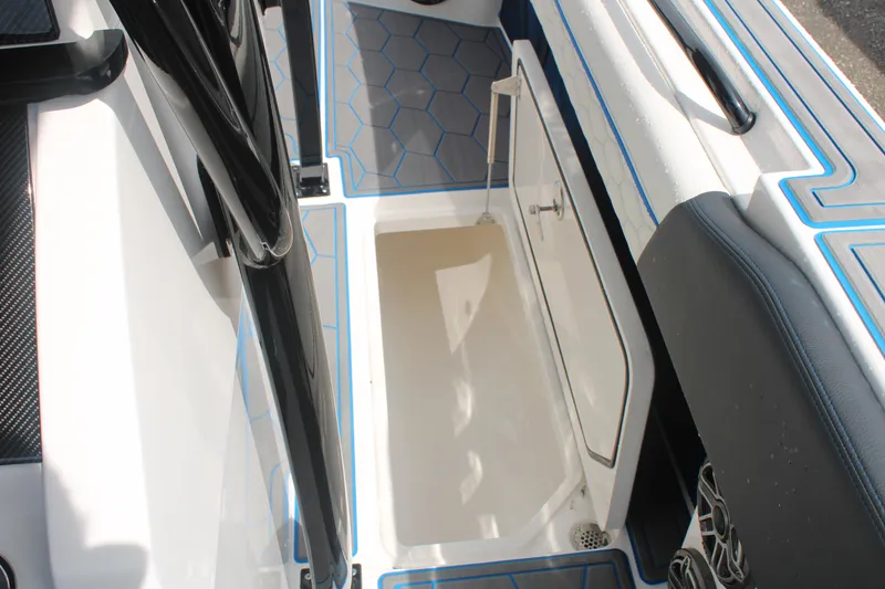 Slide: The Image of 2024 Fountain 34 SC boat interior with open storage compartment and hexagonal floor design. - 46