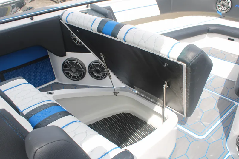Slide: The Image of 2024 Fountain 34 SC boat interior with open storage compartment and stylish seating. - 47