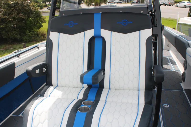 Slide: The Image of 2024 Fountain 34 SC boat seats with blue and white upholstery, featuring cup holders. - 48