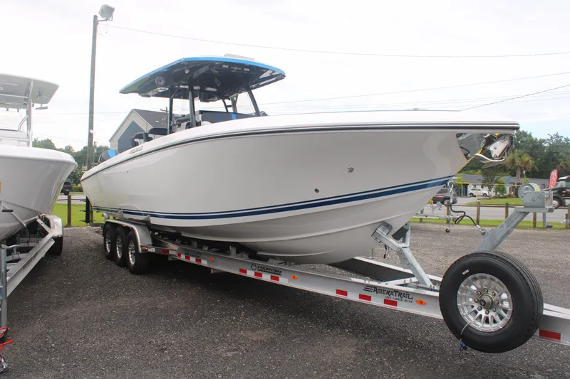 Slide: The Image of 2024 Fountain 34 SC boat on trailer, side view, outdoors. - 5