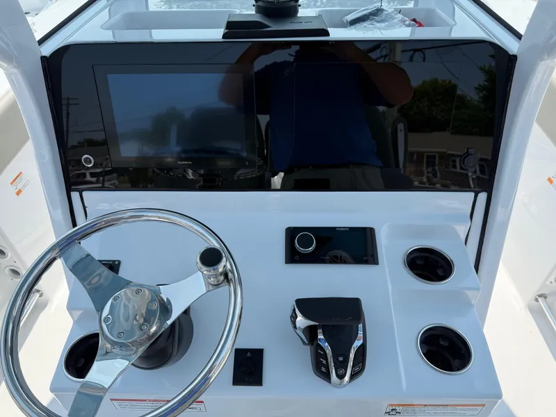 Slide: The Image of 2025 Sportsman Heritage 261 Center Console dashboard with steering wheel and modern controls. - 15