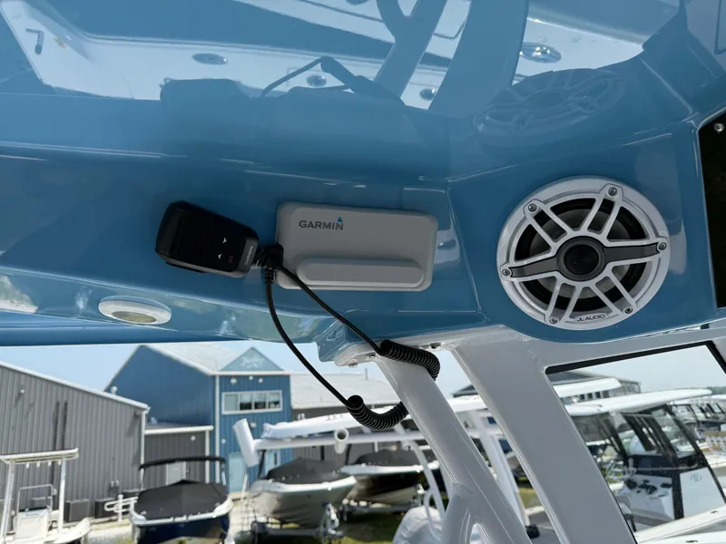 Slide: The Image of 2025 Sportsman Heritage 261 Center Console with Garmin device and speaker, docked at marina. - 16