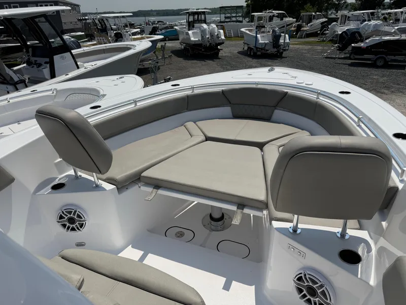 Slide: The Image of 2025 Sportsman Heritage 261 Center Console boat with cushioned seating and speakers. - 19