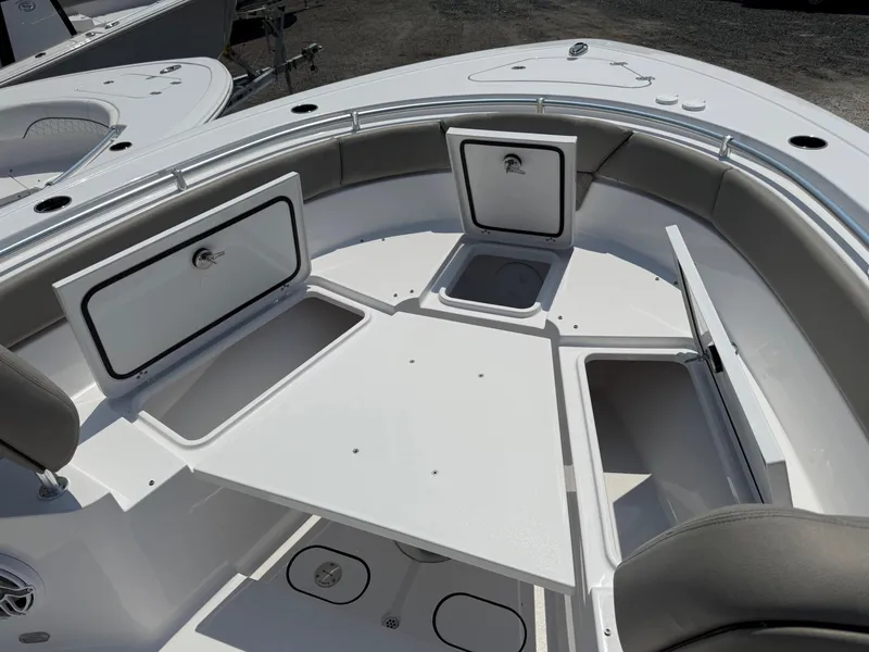 Slide: The Image of 2025 Sportsman Heritage 261 Center Console boat interior with storage compartments and seating. - 21