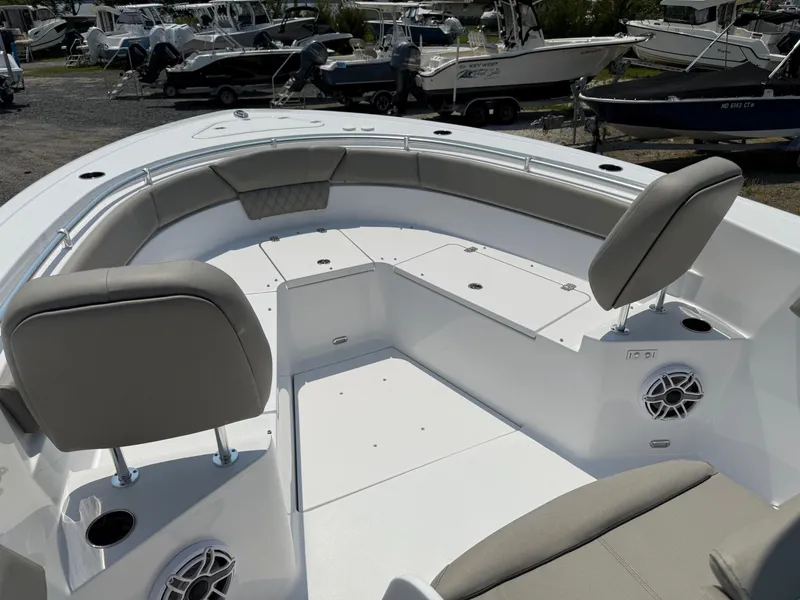Slide: The Image of 2025 Sportsman Heritage 261 Center Console boat interior with cushioned seating and storage compartments. - 22