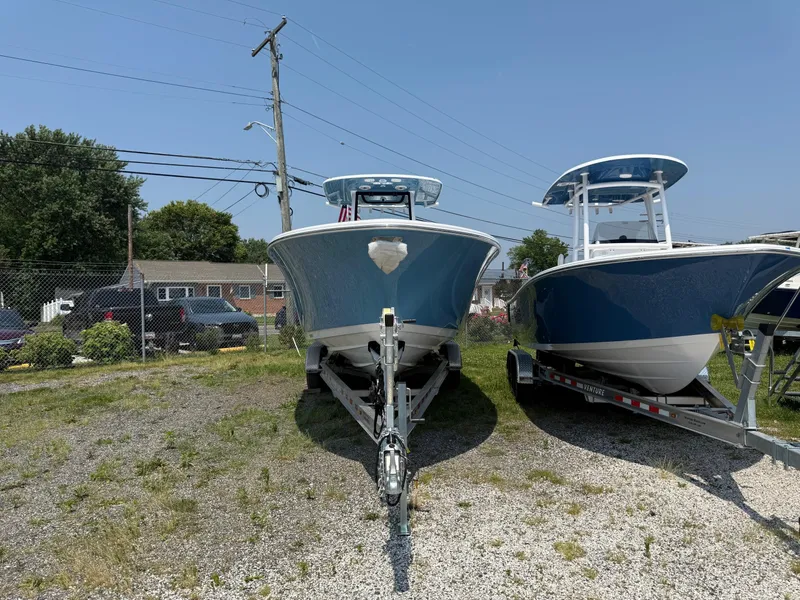 Slide: The Image of 2025 Sportsman Heritage 261 Center Console boat on trailer, parked outdoors. - 3