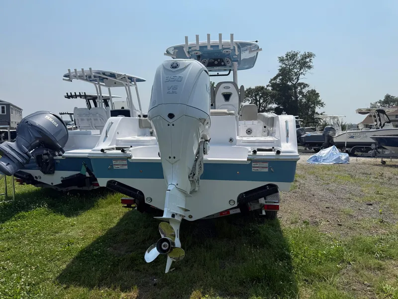 Slide: The Image of 2025 Sportsman Heritage 261 Center Console boat, rear view, parked on grass. - 4