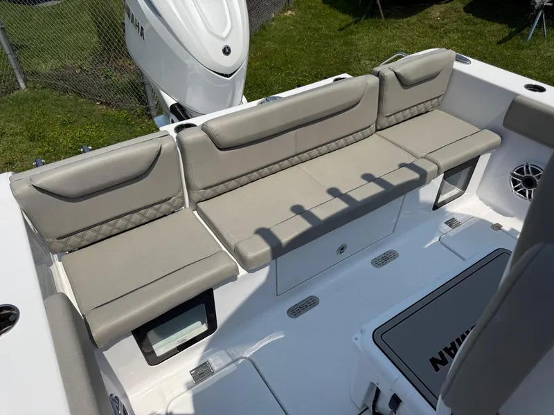 Slide: The Image of 2025 Sportsman Heritage 261 Center Console boat with beige seating and storage compartments. - 6