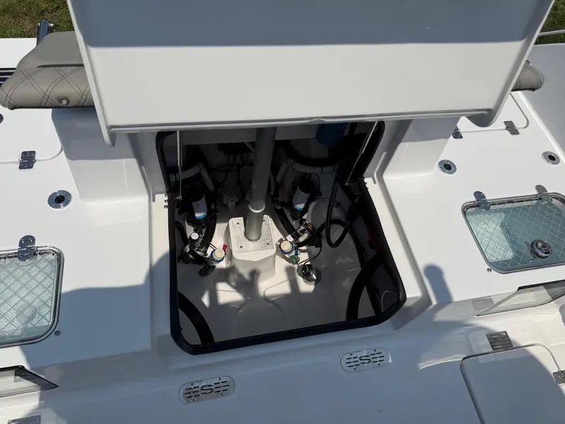 Slide: The Image of 2025 Sportsman Heritage 261 Center Console boat interior with open hatch, showcasing equipment. - 8