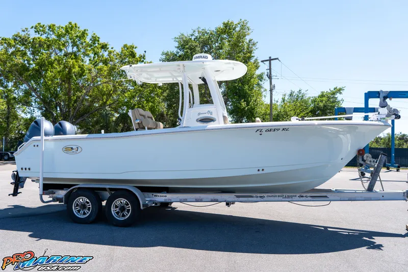 Slide: The Image of 2017 Sea Hunt Gamefish 25 boat on trailer, parked outdoors. - 12