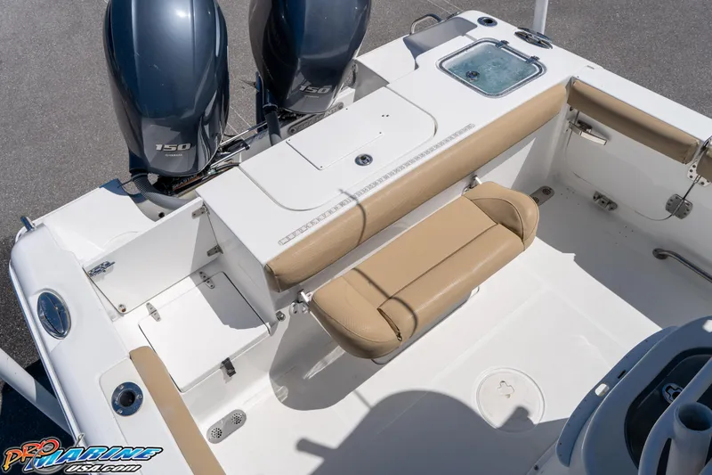 Slide: The Image of 2017 Sea Hunt Gamefish 25 boat interior with dual engines and tan seating. - 17