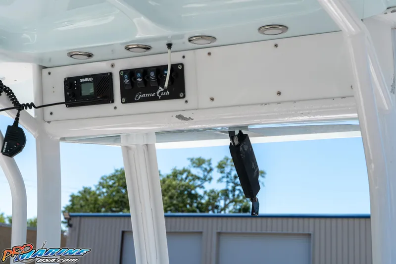 Slide: The Image of 2017 Sea Hunt Gamefish 25 boat console with electronic controls and overhead panel. - 20