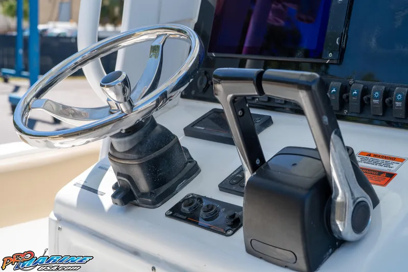 Slide: The Image of Steering wheel and controls of a 2017 Sea Hunt Gamefish 25 boat. - 24