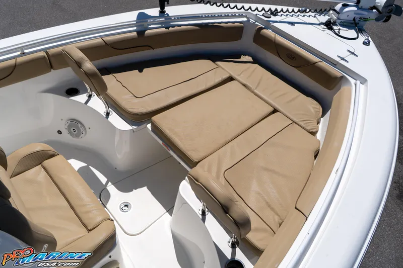 Slide: The Image of 2017 Sea Hunt Gamefish 25 boat with tan cushioned seating in the bow area. - 29