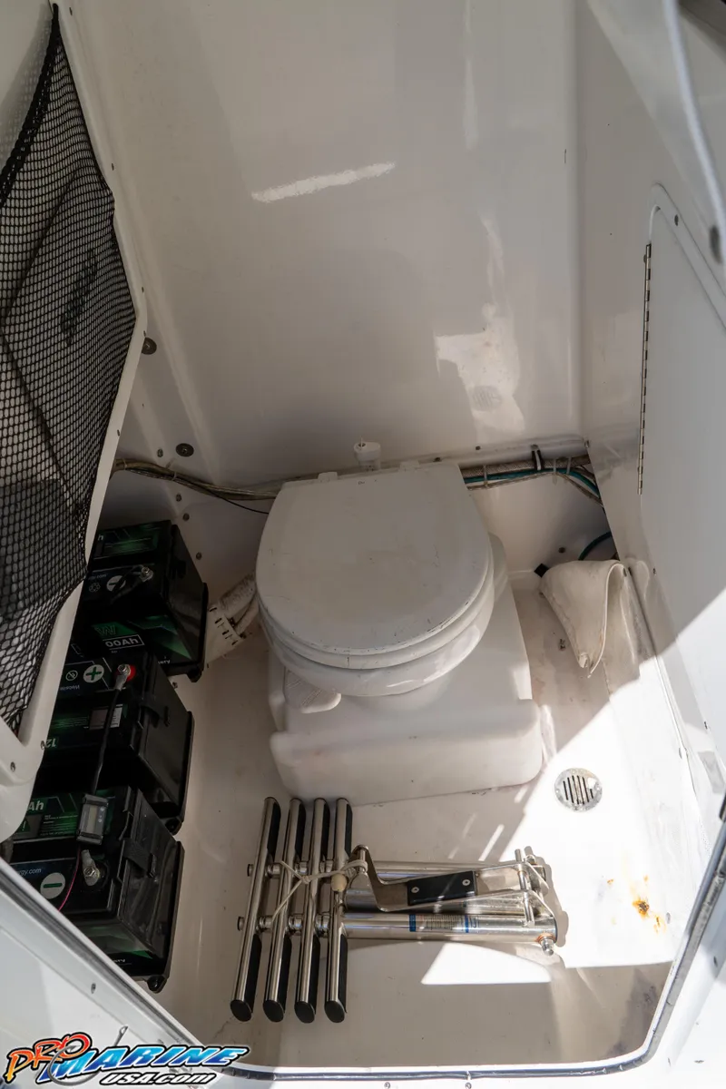 Slide: The Image of 2017 Sea Hunt Gamefish 25 boat interior with toilet and storage area. - 30