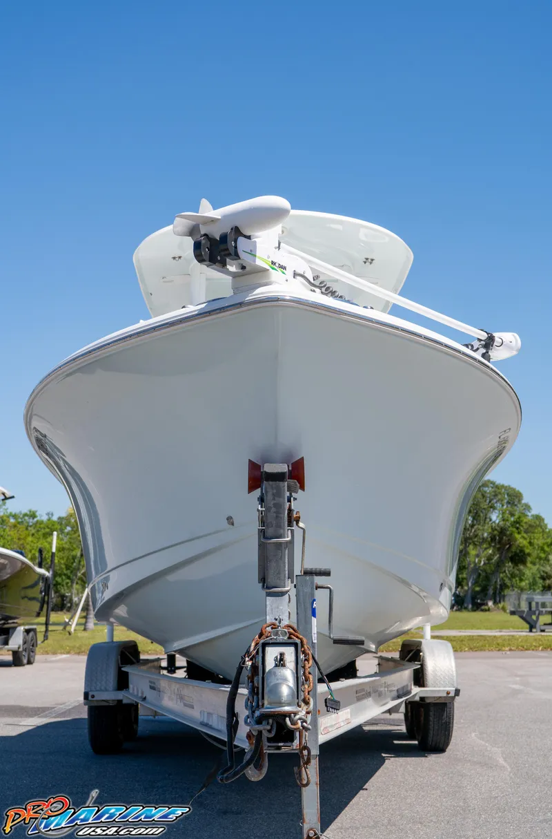 Slide: The Image of 2017 Sea Hunt Gamefish 25 boat on trailer, viewed from front under clear blue sky. - 4