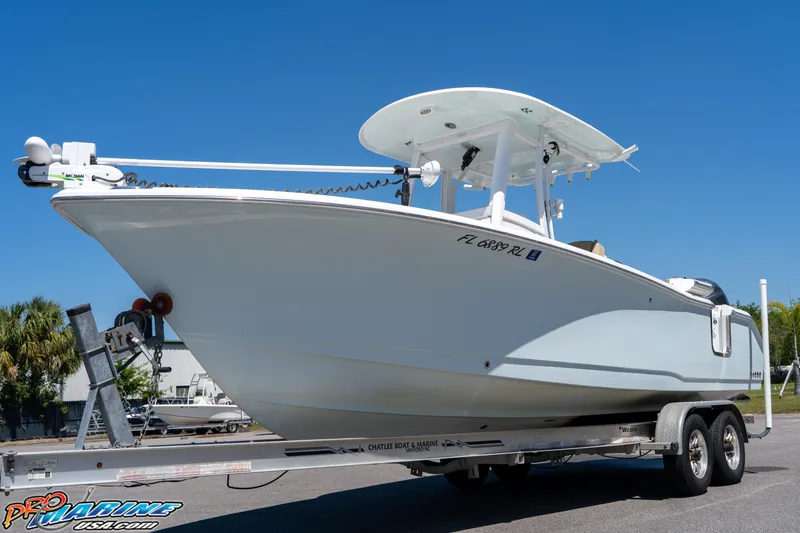 Slide: The Image of 2017 Sea Hunt Gamefish 25 boat on trailer, parked outdoors under clear blue sky. - 5