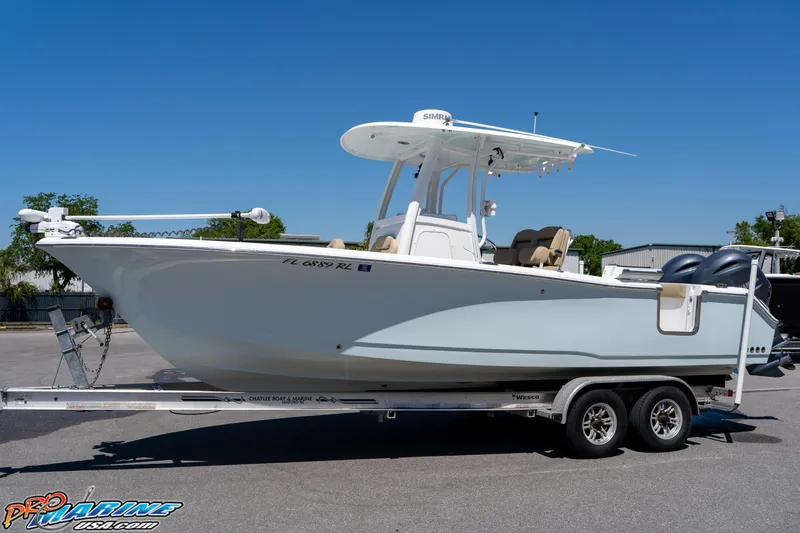 Slide: The Image of 2017 Sea Hunt Gamefish 25 boat on trailer, parked outdoors under clear blue sky. - 6